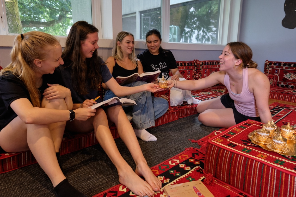 Students chat and work with their tea at the Arabic School.