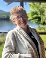 A woman smiles at the camera.